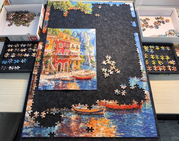 How to Frame a Puzzle: A Step-by-Step Guide 1 assembling a puzzle on a board
